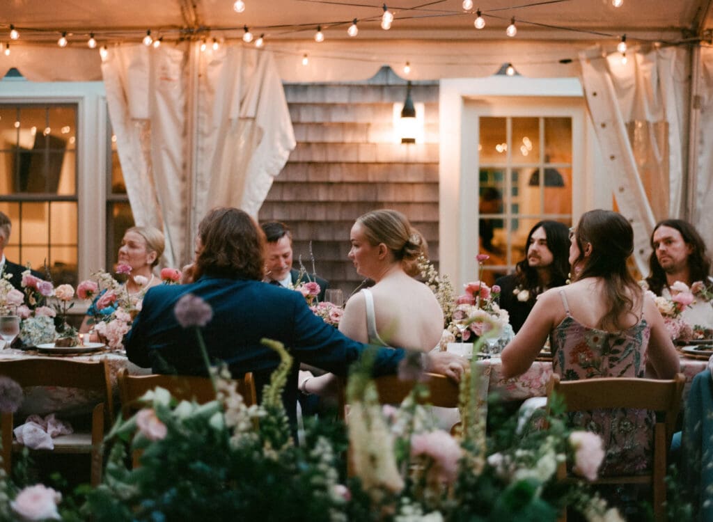 Guests, bride, and groom listen to speeches