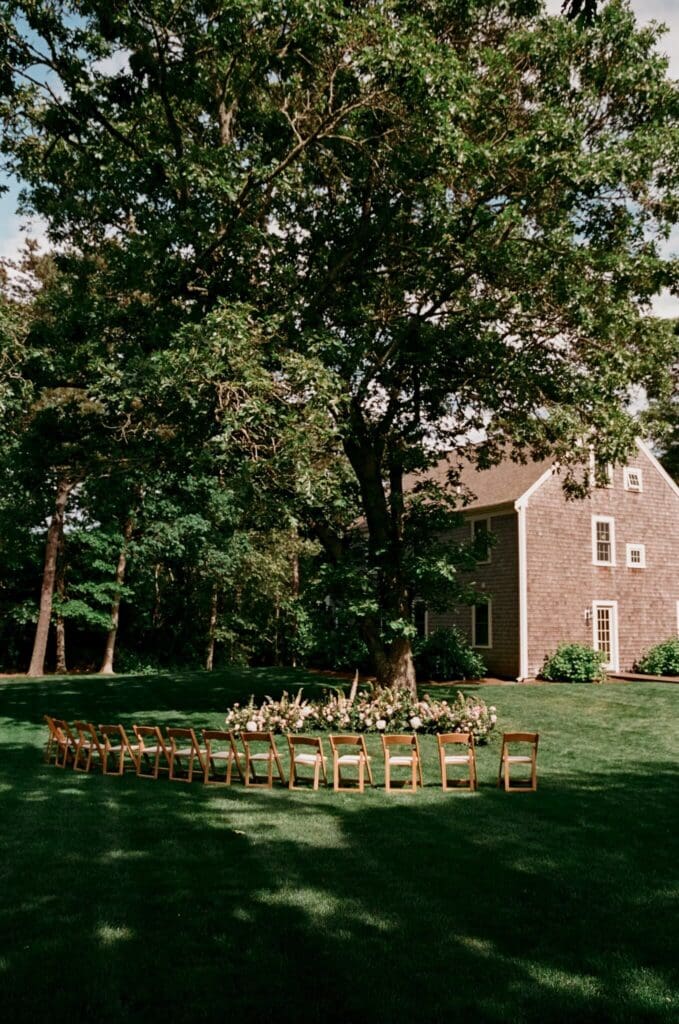 Lush grounded floral aisle installation for a microwedding in a Cape Cod garden setting