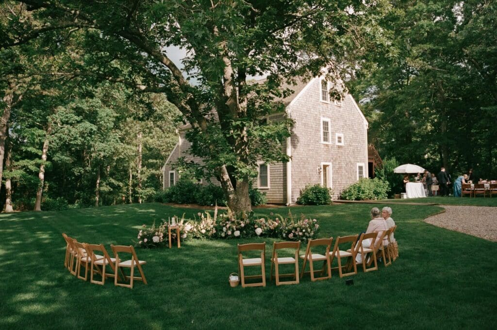 Textural floral arch installation in a Cape Cod backyard wedding ceremony space