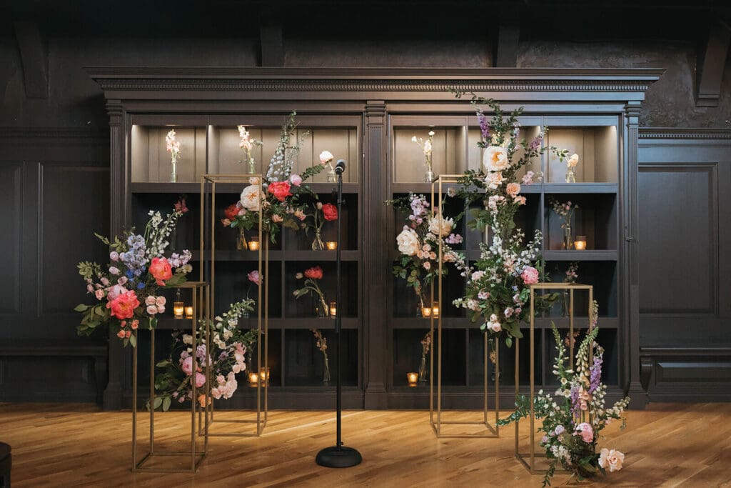 Innovative installation for cohesive wedding flowers with vibrant, movement-filled blooms in bold pink, coral, and peach hues