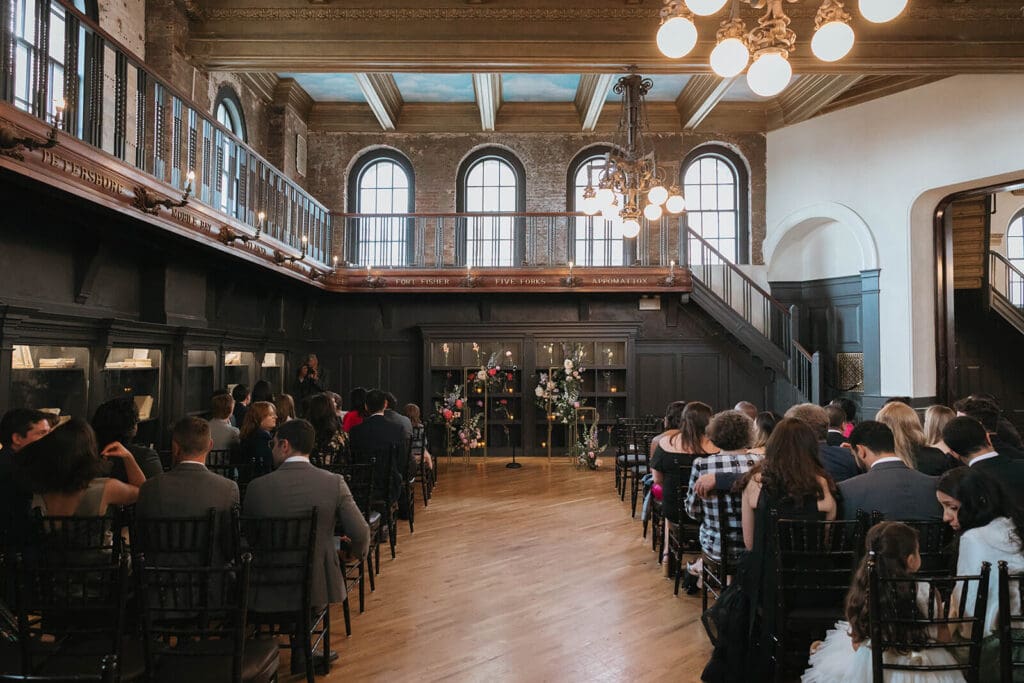 Boston wedding ceremony setup in a historic venue with bold floral installations and grand architectural details